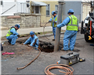 Public Works Employees Doing Plumbing Work